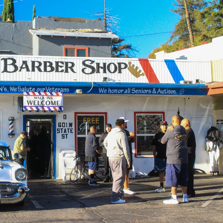 Men talking outside the shop after the study